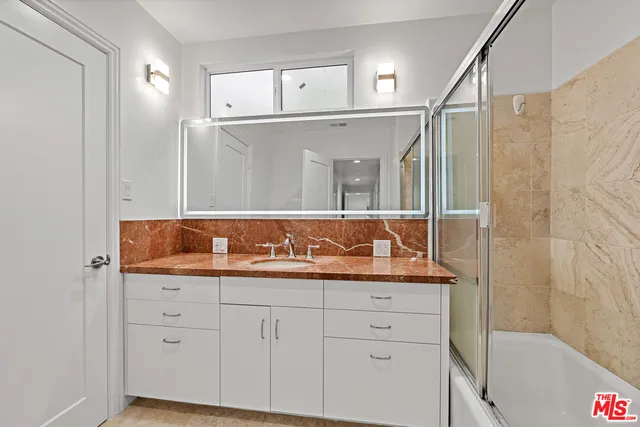 a bathroom with a granite countertop sink mirror and double