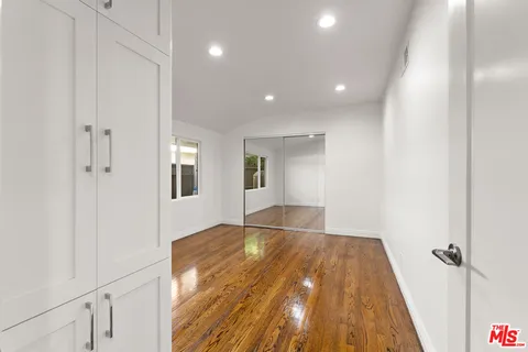 a view of an empty room and wooden floor
