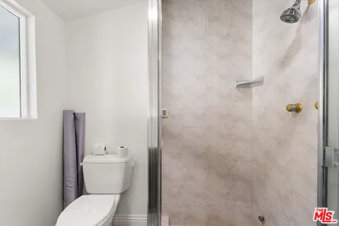 a white toilet sitting next to a bathroom sink