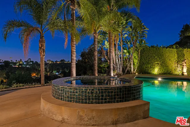 a view of swimming pool with a yard and lake view