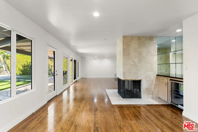 a view of living room with furniture and a fireplace