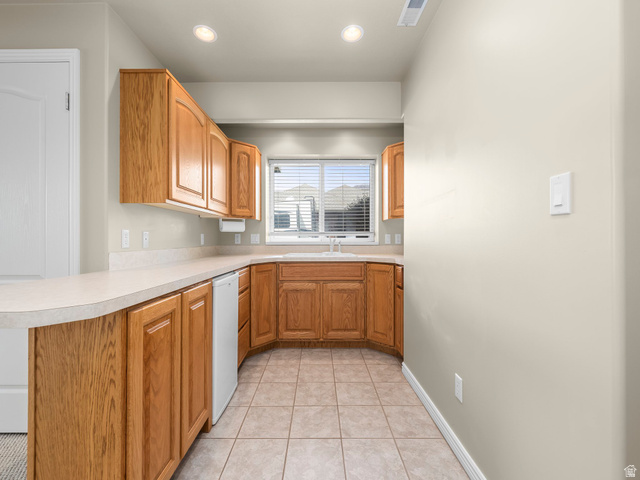 6849 North Black Powder Road Mountain Green, UT 84050 - Photo 22 of 43 Kitchenette featuring wood cabinetry, laminate countertops, a built-in sink, an under-counter appliance, and recessed lighting