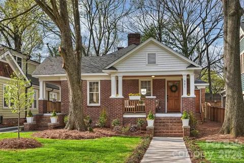 a front view of a house with a yard table and chairs