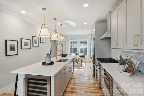 a kitchen with sink a stove and cabinets