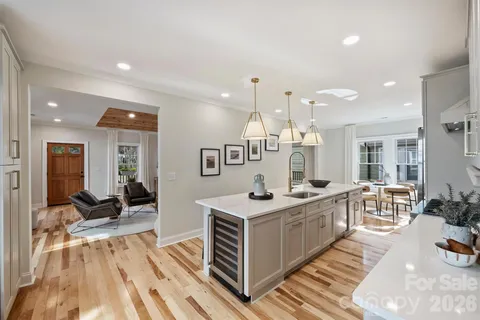 a large kitchen with stainless steel appliances kitchen island granite countertop a sink and cabinets