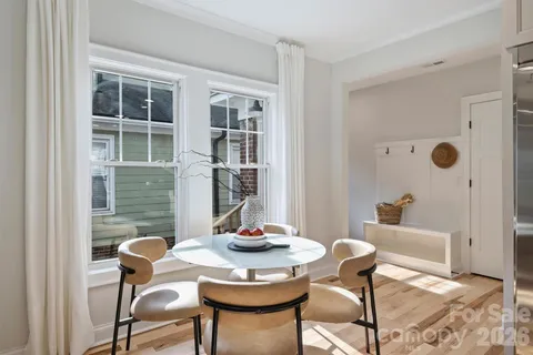 a dining room with furniture and window