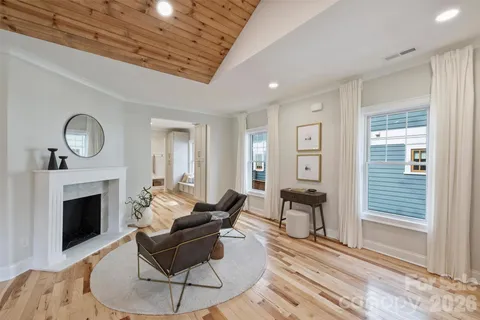 a living room with furniture a fireplace and a table
