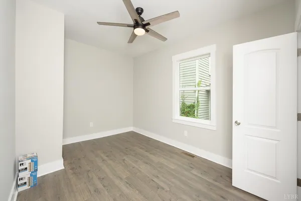a view of an empty room with a fan