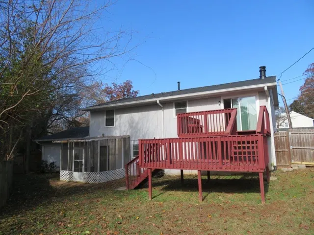a view of a house with a yard and deck