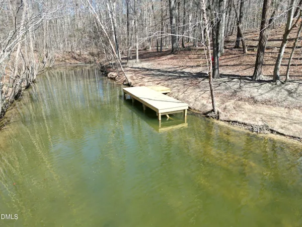 a small pool with lawn chairs