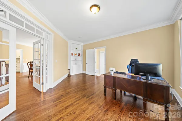 a view of a workspace with furniture and wooden floor