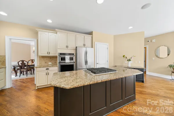 a dining room with wooden floor and a window