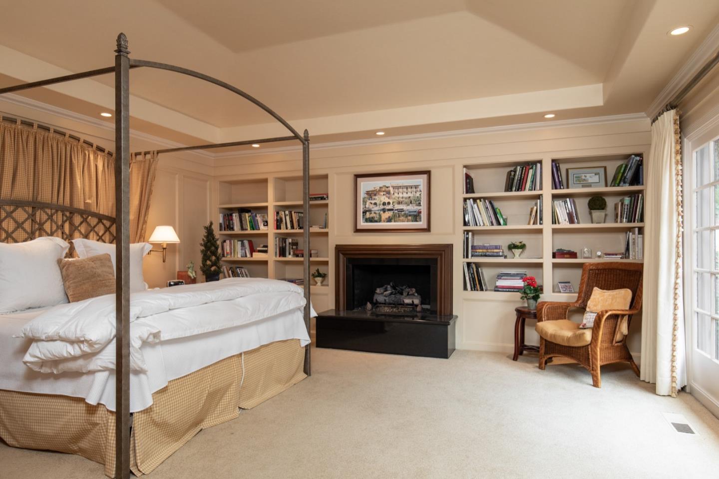 1427 Riata Road Pebble Beach, CA 93953 - Photo 14 of 24 a bedroom with furniture and a fireplace