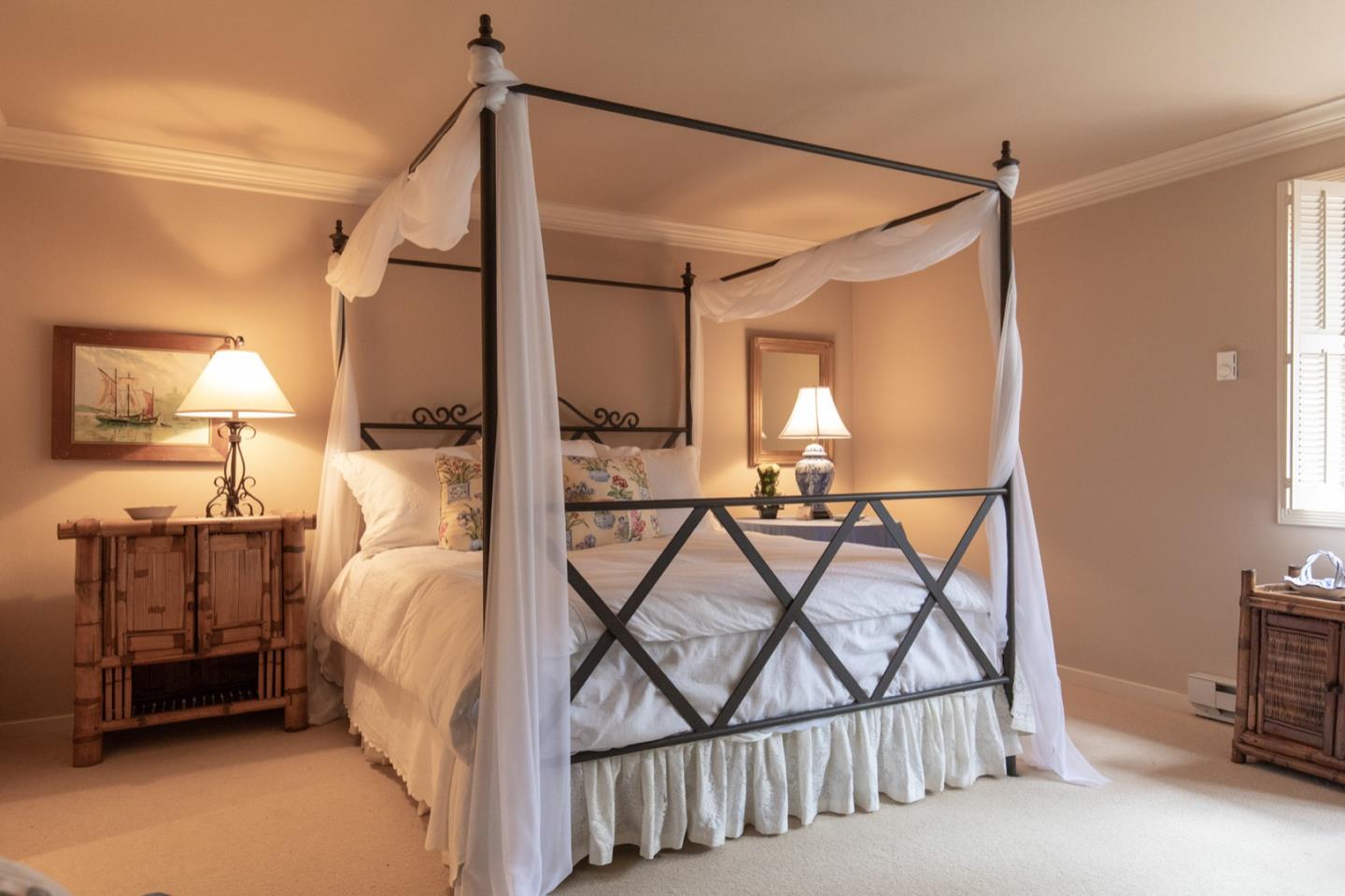 1427 Riata Road Pebble Beach, CA 93953 - Photo 16 of 24 a bedroom with a bed a lamp and a flat tv screen on the dresser
