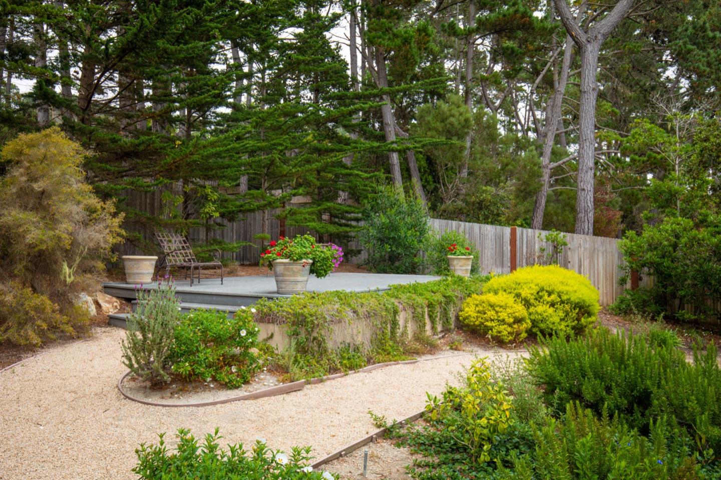 1427 Riata Road Pebble Beach, CA 93953 - Photo 19 of 24 a view of a garden with large trees