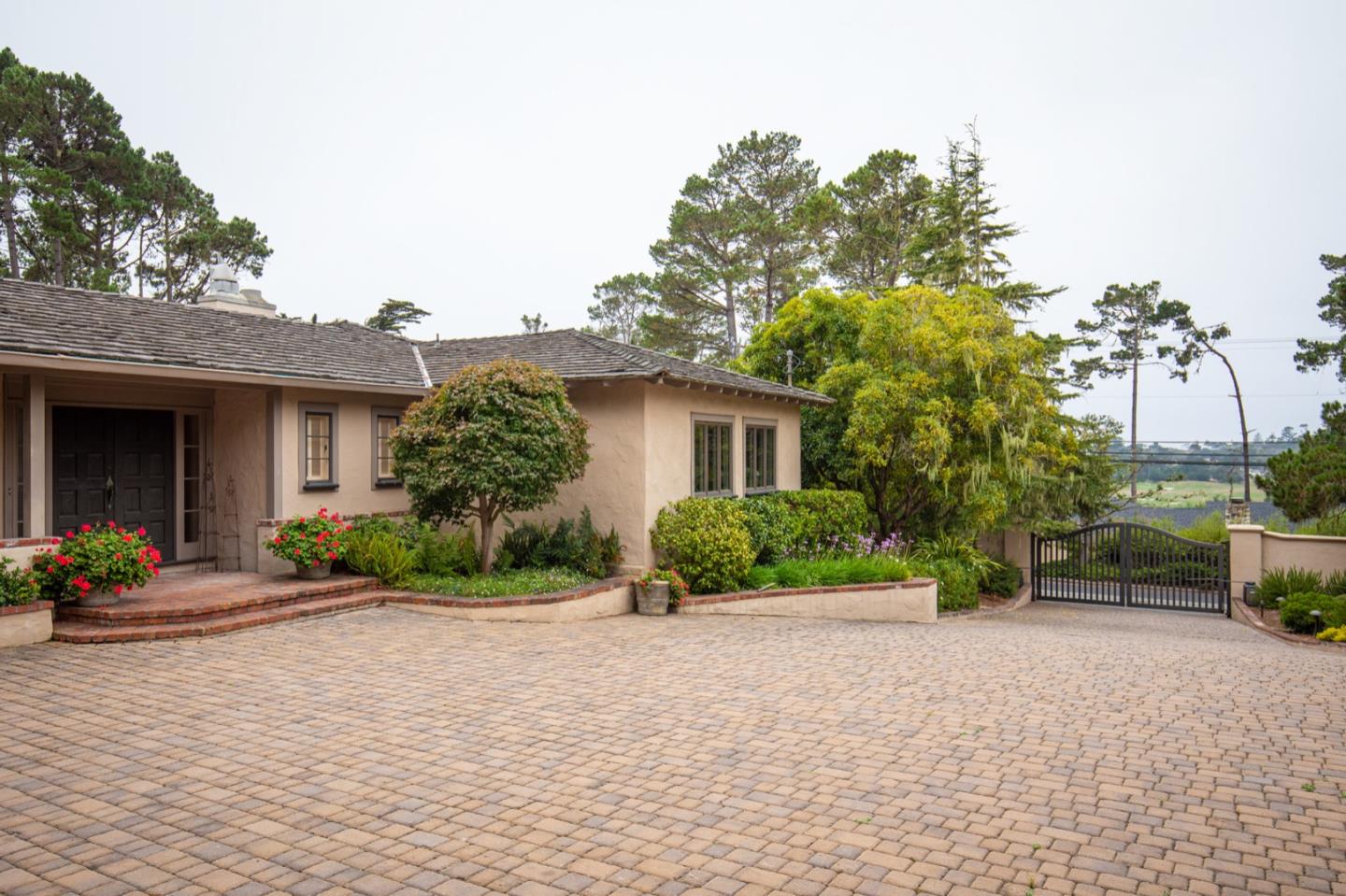 1427 Riata Road Pebble Beach, CA 93953 - Photo 3 of 24 a front view of a house with garden