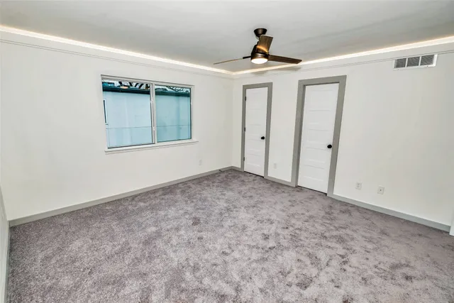 a view of walk in closet with empty racks