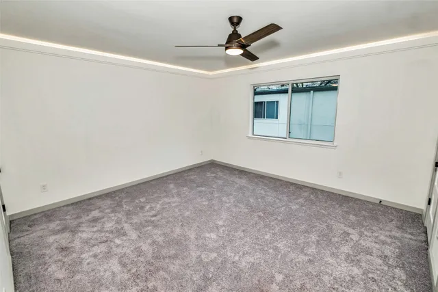 a view of a livingroom with a ceiling fan and window