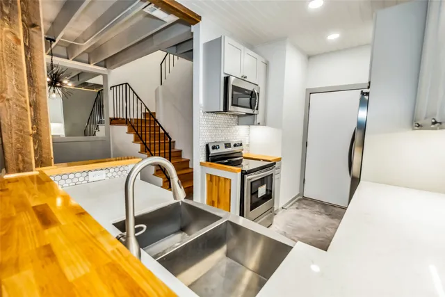 a kitchen with wooden cabinets and sink