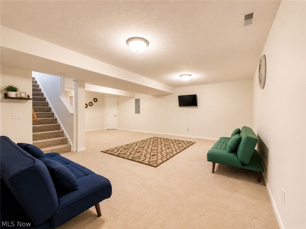 867 Starr Ridge Street Southeast Massillon, OH 44646 - Photo 22 of 29 Spacious lower-level room featuring neutral carpeting, recessed lighting, and a carpeted staircase