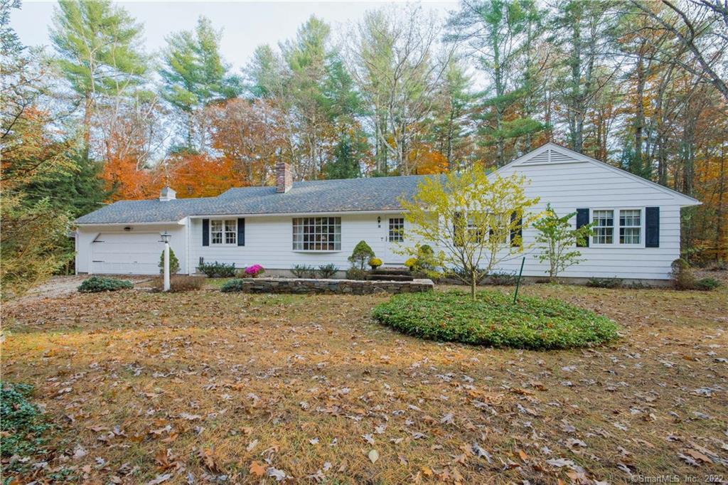 47 Canton Road Simsbury, CT 06070 - Photo 1 of 1 a view of a yard in front of a house with plants and large tree
