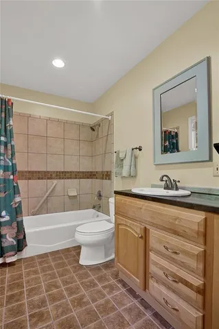 a bathroom with a toilet a sink and bathtub