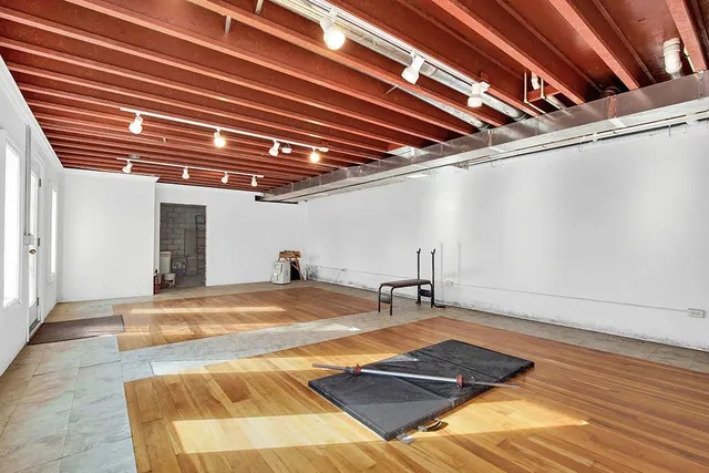 a view of a hall with wooden floor