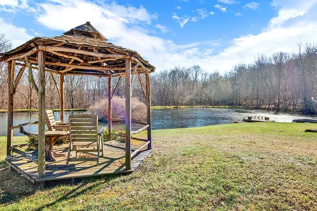 a view of a backyard with table and chairs