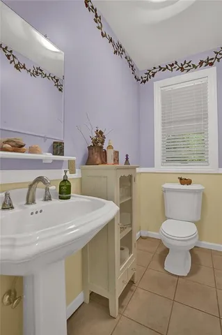 a bathroom with a sink toilet and a mirror