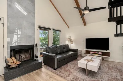 a kitchen with granite countertop a stove top oven a sink dishwasher a dining table and chairs with wooden floor