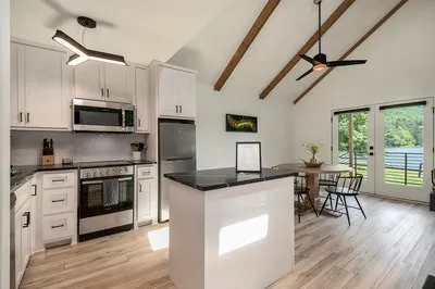 a living room with furniture a fireplace and a flat screen tv