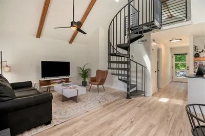 a bedroom with two beds and wooden floor