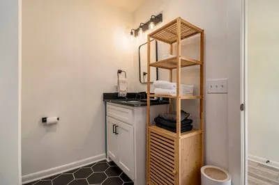 a kitchen with stainless steel appliances granite countertop a stove a refrigerator a sink dishwasher with a dining table and chairs with wooden floor