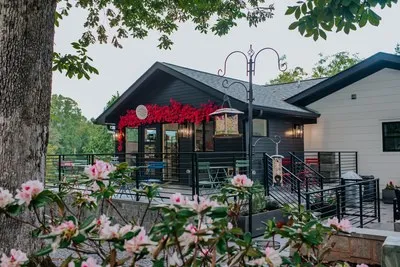 an aerial view of lake residential house with outdoor space and trees around