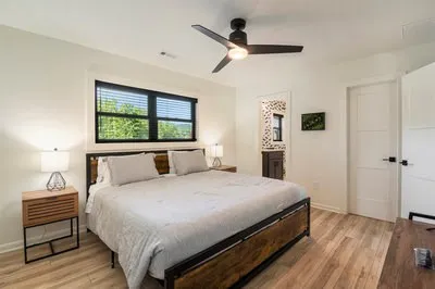 a bedroom with a bed and a flat screen tv