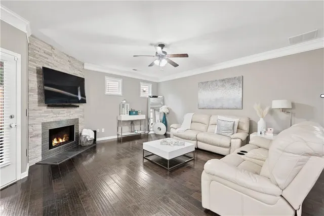 a living room with furniture a fireplace and a flat screen tv