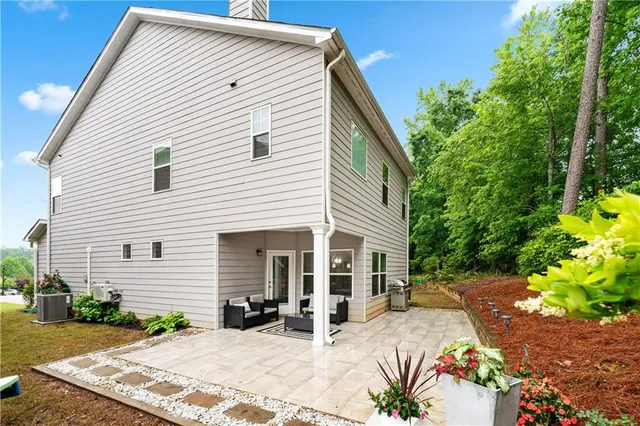 a view of a patio with table and chairs with wooden fence and plants