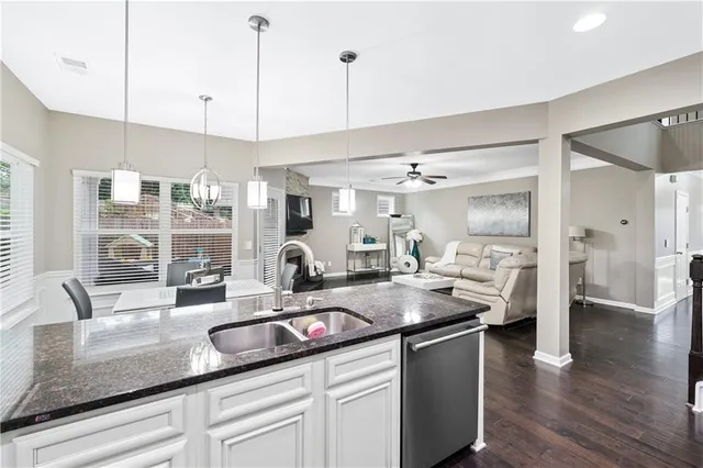 a kitchen with a sink a stove and cabinets