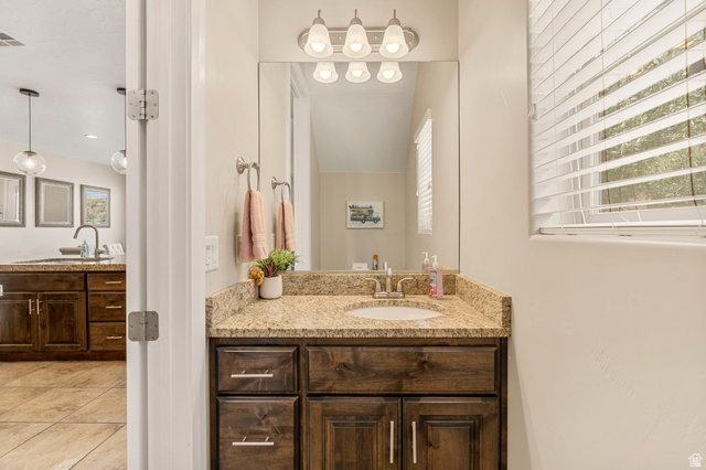 4257 Razor Drive Washington, UT 84780 - Photo 23 of 58 Bathroom vanity with granite countertop, integrated sink, and dark wood cabinetry