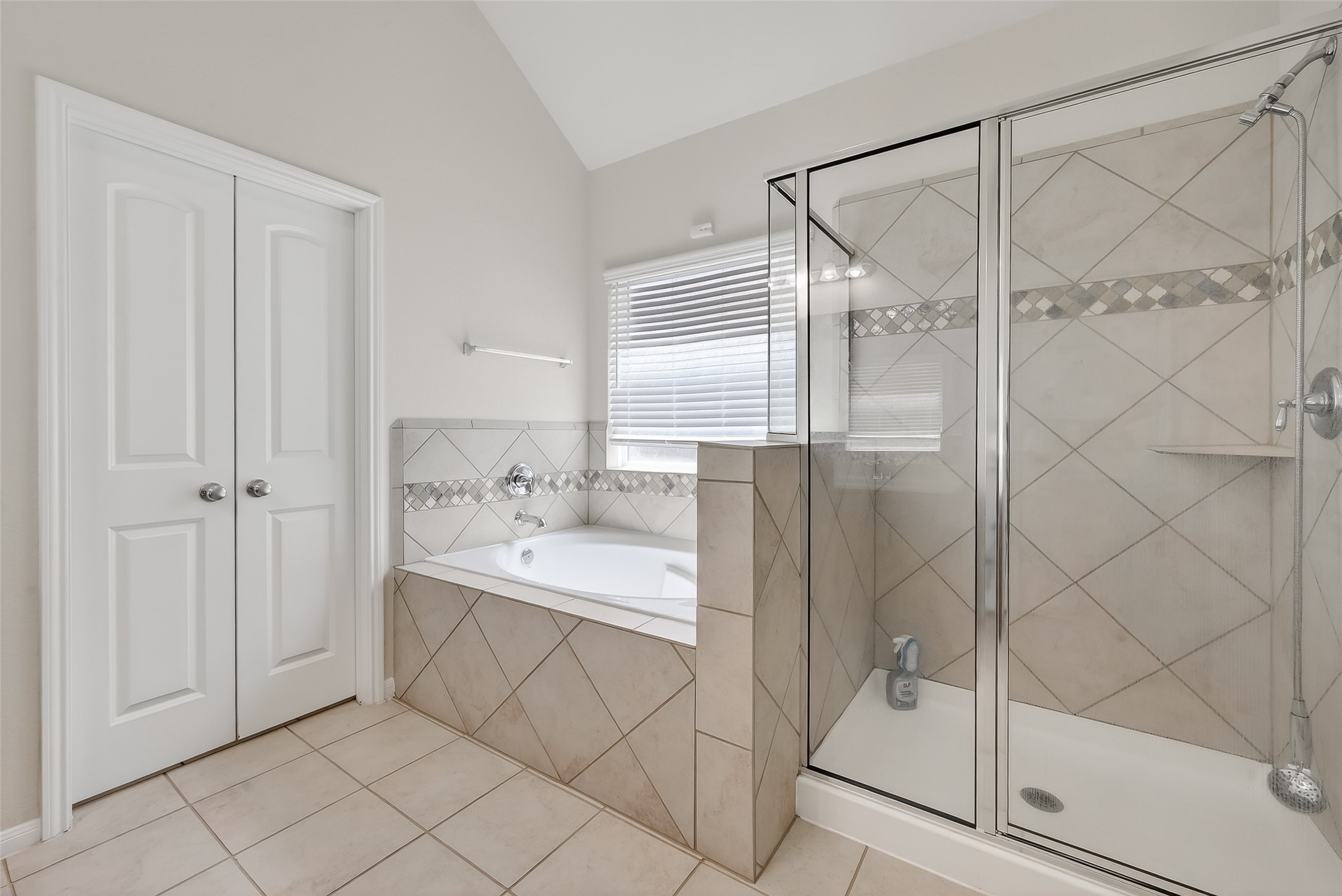 7631 Granite Terrace Lane Houston, TX 77083 - Photo 29 of 46 This bathroom features a spacious design with a large soaking tub, separate glass-enclosed shower, and elegant tile work.