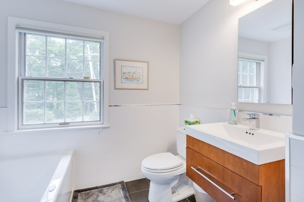 226 Conant Road Weston, MA 02493 - Photo 17 of 23 a bathroom with a sink mirror toilet and next to a window