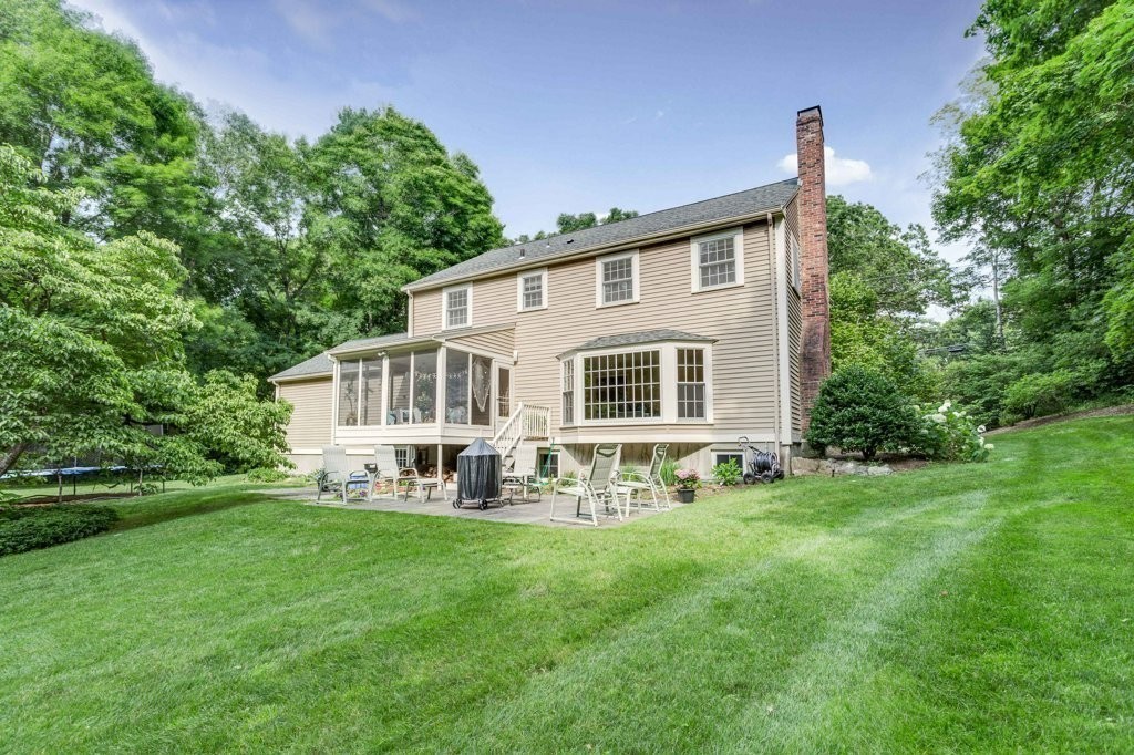226 Conant Road Weston, MA 02493 - Photo 21 of 23 a front view of a house with a yard and trees