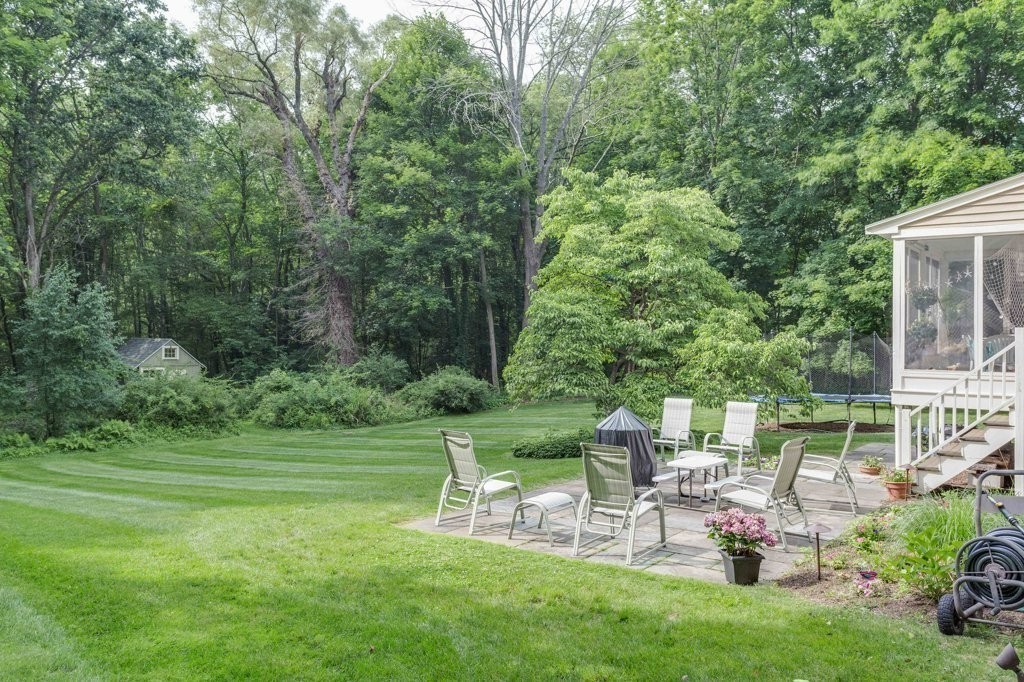 226 Conant Road Weston, MA 02493 - Photo 22 of 23 a view of a chair and table on the garden