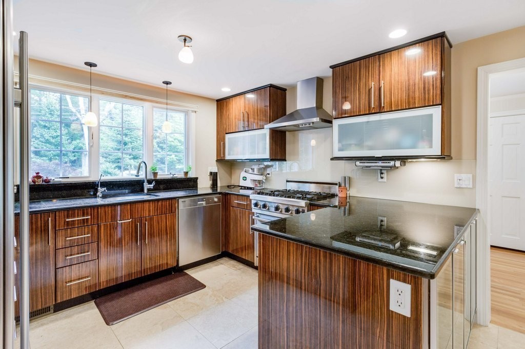 226 Conant Road Weston, MA 02493 - Photo 3 of 23 a kitchen with stainless steel appliances granite countertop a stove a sink and a microwave