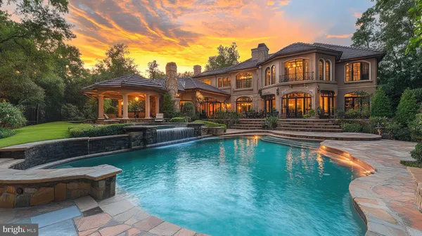 a front view of a house with swimming pool having outdoor seating