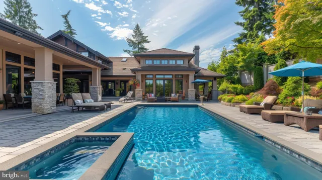 a view of a house with swimming pool and sitting area