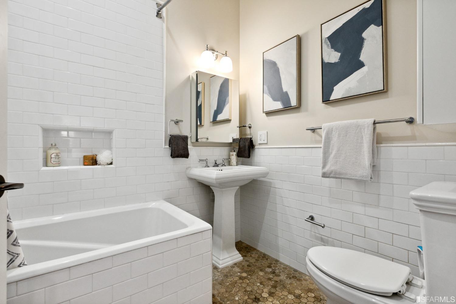 151 Broderick Street San Francisco, CA 94117 - Photo 21 of 39 a bathroom with a sink a toilet and mirror