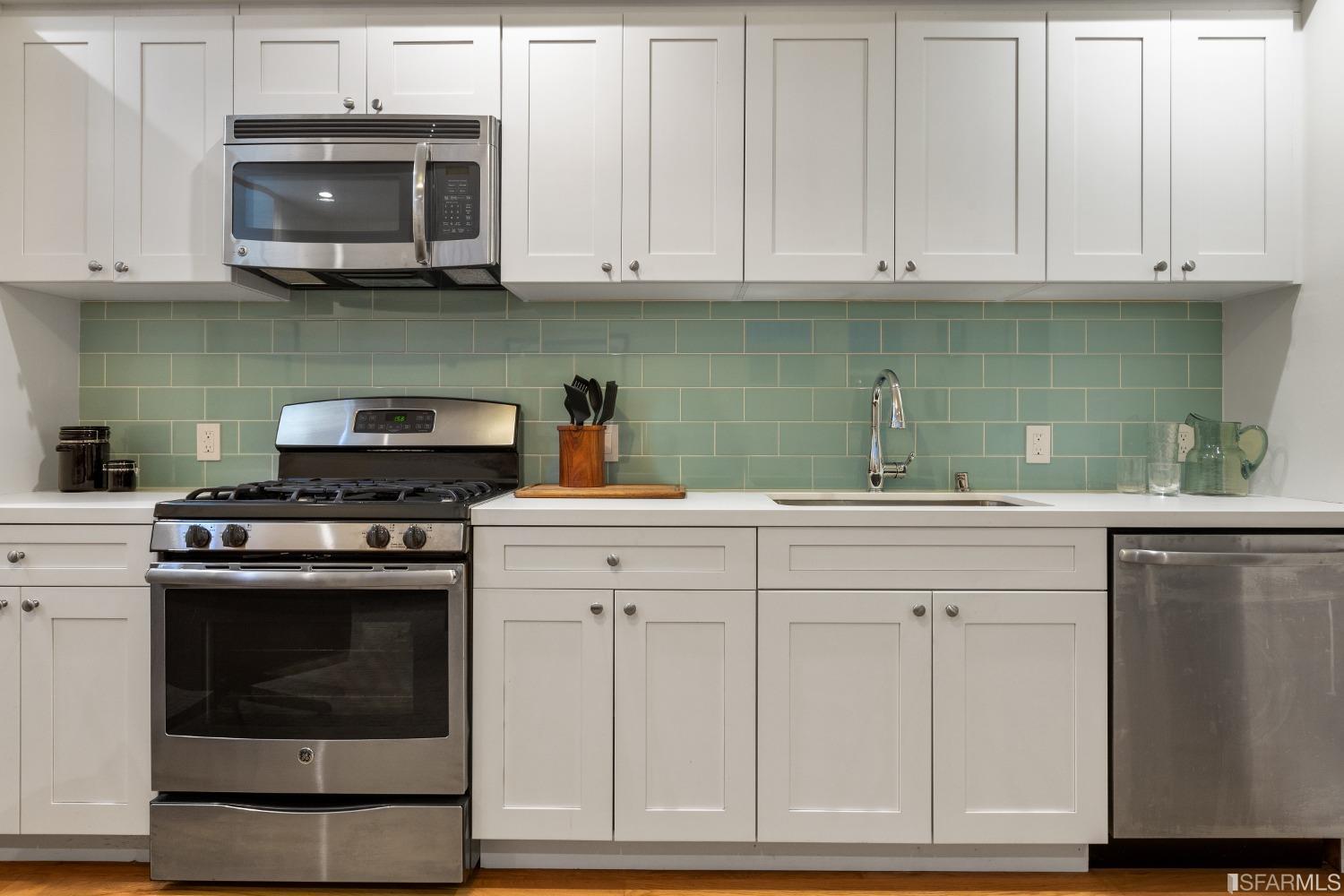 151 Broderick Street San Francisco, CA 94117 - Photo 28 of 39 a kitchen with granite countertop white cabinets and stainless steel appliances