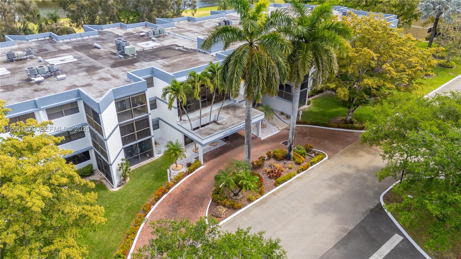 16251 Golf Club Road, Unit 311 Weston, FL 33326 - Photo 4 of 38 an aerial view of residential house with outdoor space and trees all around