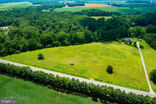 a view of a large pool with an outdoor space and seating area